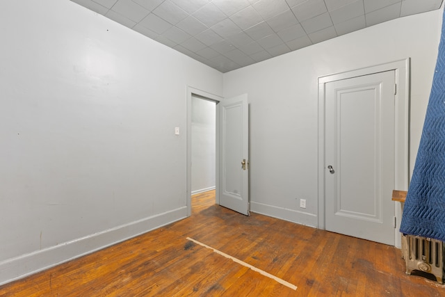 unfurnished bedroom with dark wood-type flooring