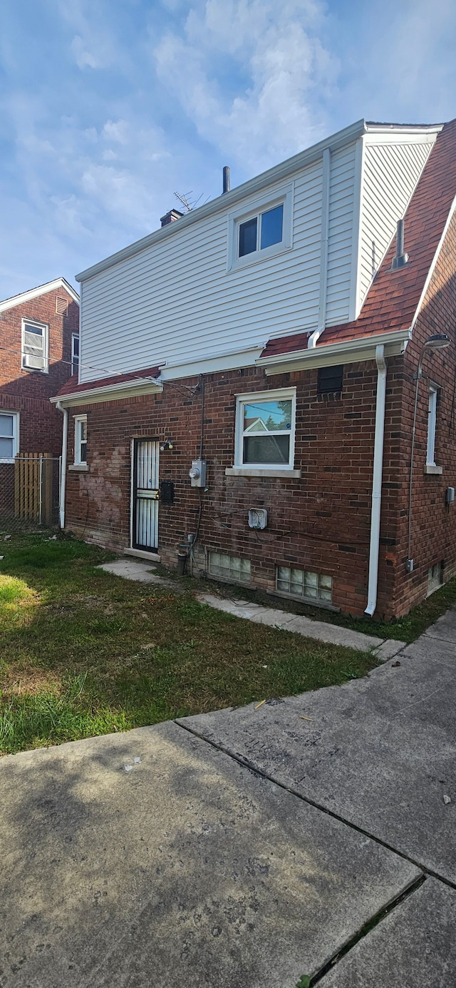 rear view of property with a yard