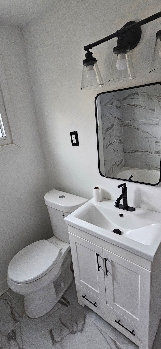 bathroom featuring vanity and toilet