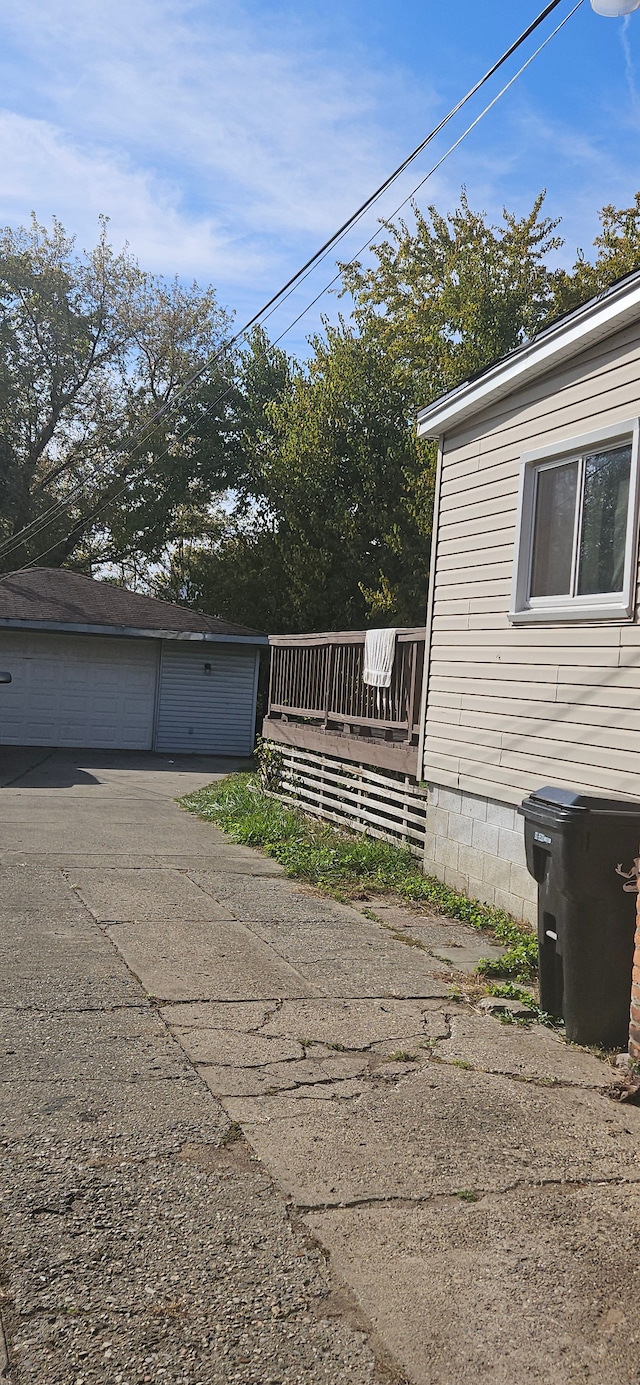 view of side of property with a garage and an outbuilding