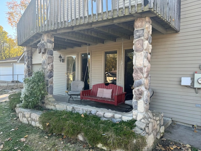 entrance to property with a balcony and a patio