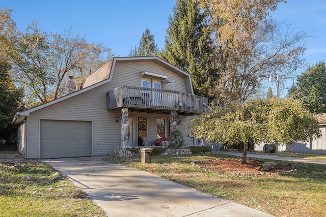 front of property with a front yard, a balcony, and a garage