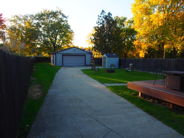 exterior space with a garage, a deck, and a storage unit