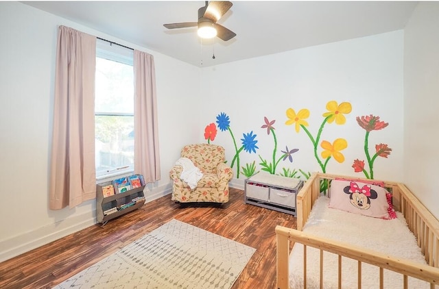 bedroom with ceiling fan and dark wood-type flooring