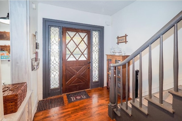 entryway with dark hardwood / wood-style flooring