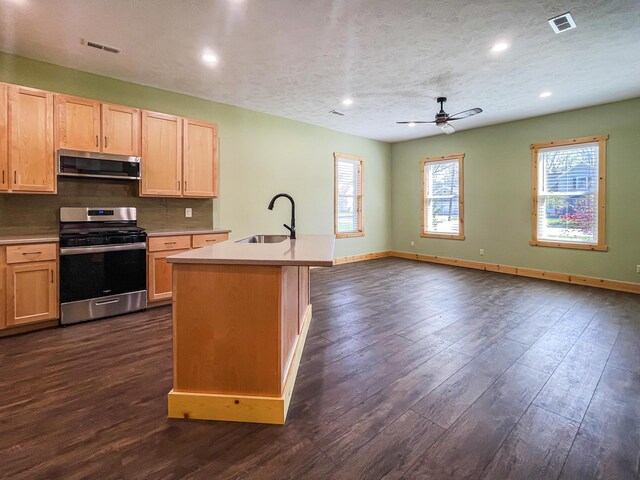 620 S Main St, Wayland, MI 49348 - kitchen featuring appliances with stainless steel finishes, a sink, light brown cabinetry, ceiling fan, and light countertops