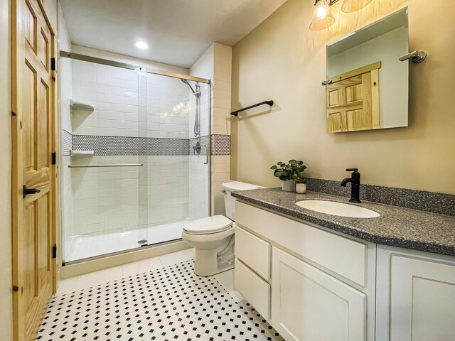 620 S Main St, Wayland, MI 49348 - bathroom with vanity, a stall shower, toilet, and tile patterned flooring