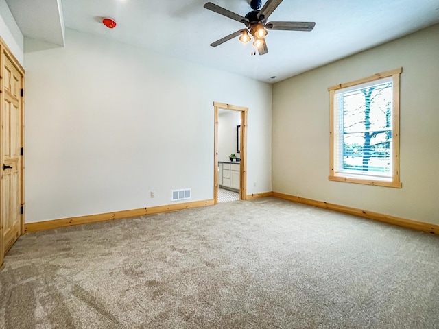 carpeted spare room with ceiling fan