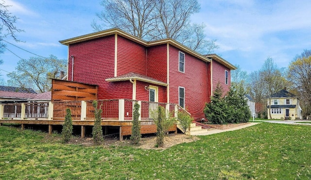 back of property featuring a yard and a deck