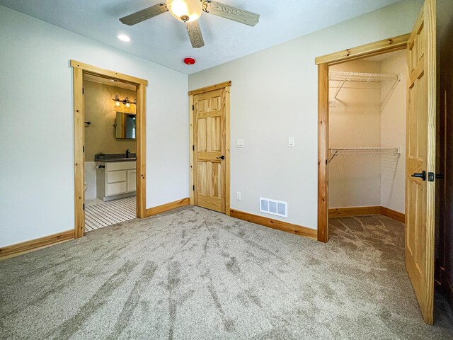 620 S Main St, Wayland, MI 49348 - unfurnished bedroom featuring baseboards, carpet, a walk in closet, recessed lighting, and connected bathroom