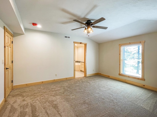 empty room with light colored carpet, ceiling fan, and lofted ceiling