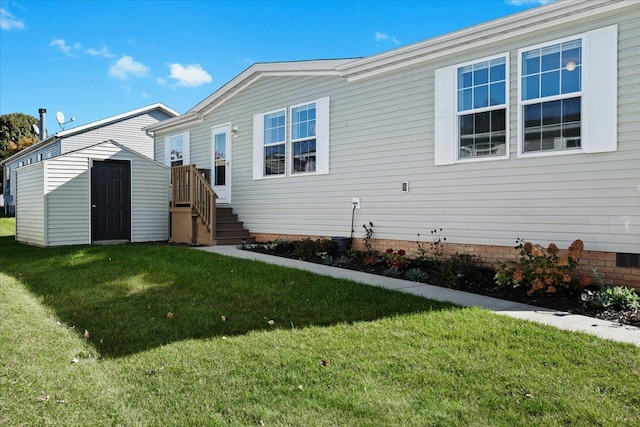 rear view of property with a lawn and a storage shed