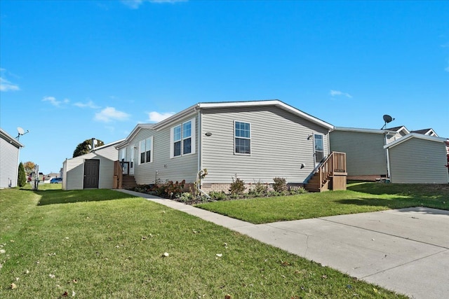 view of side of property with a yard and a storage unit