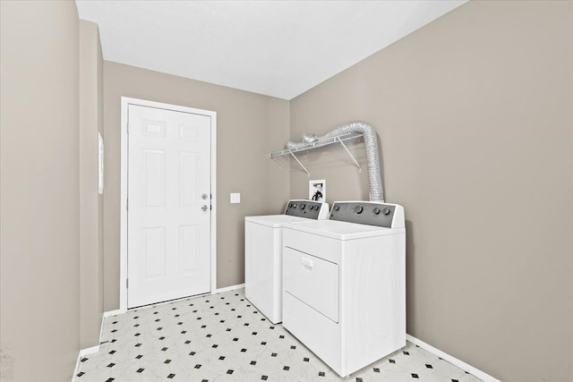 clothes washing area with separate washer and dryer