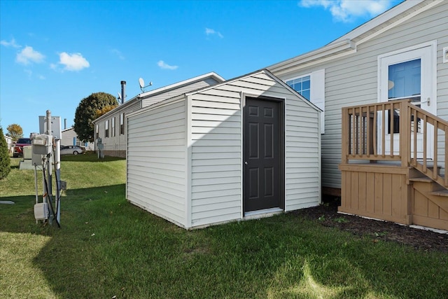 view of outbuilding with a yard