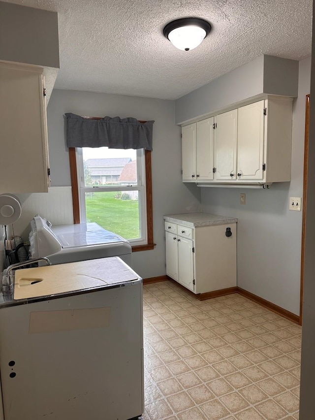 laundry room with washer / dryer and a textured ceiling