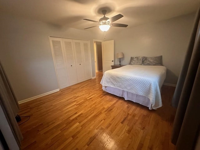 bedroom with wood-type flooring, a closet, and ceiling fan