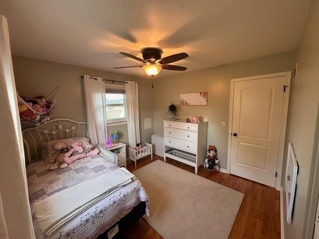 bedroom featuring ceiling fan and dark hardwood / wood-style floors