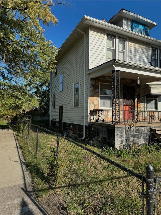 view of side of property featuring a porch