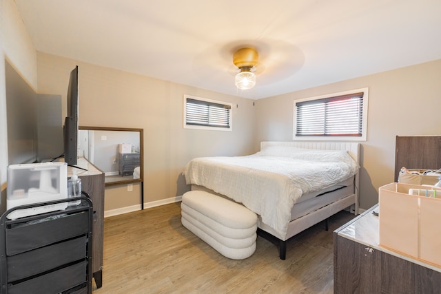 bedroom with light hardwood / wood-style flooring and ceiling fan