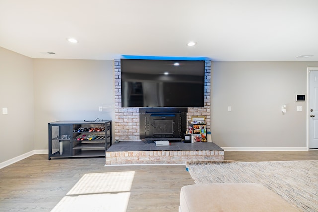 living room with wood-type flooring and a wood stove