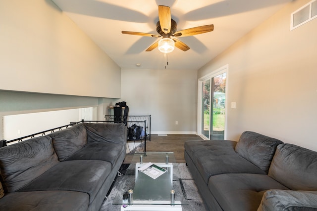 living room featuring hardwood / wood-style flooring, ceiling fan, and vaulted ceiling