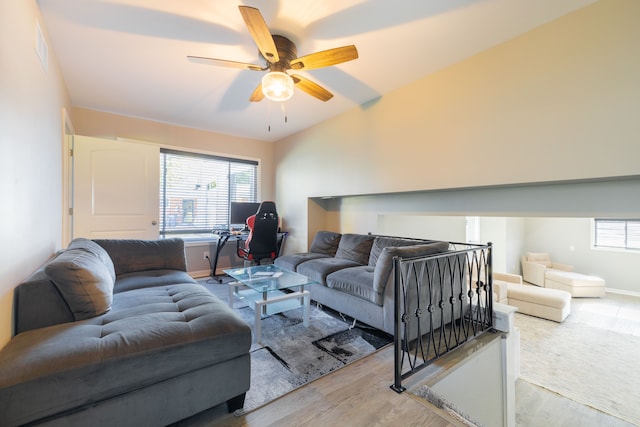 living room with ceiling fan and light hardwood / wood-style flooring