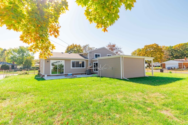 back of house with a yard and a patio