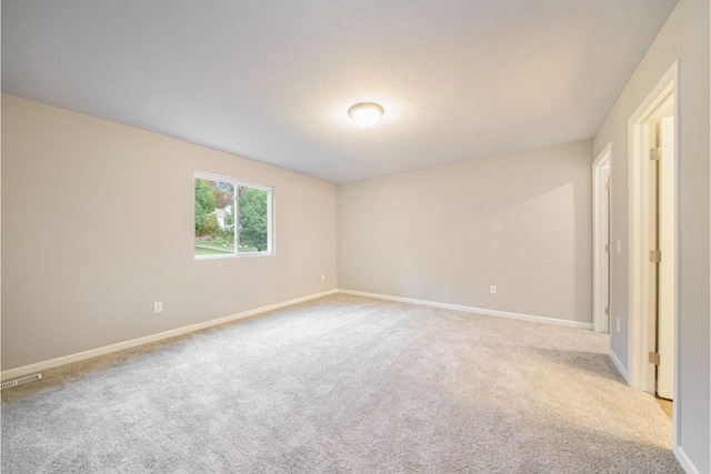 empty room with light colored carpet