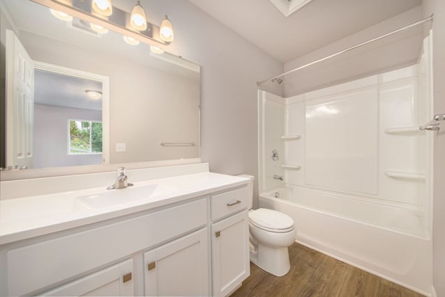 full bathroom with hardwood / wood-style floors, vanity,  shower combination, and toilet