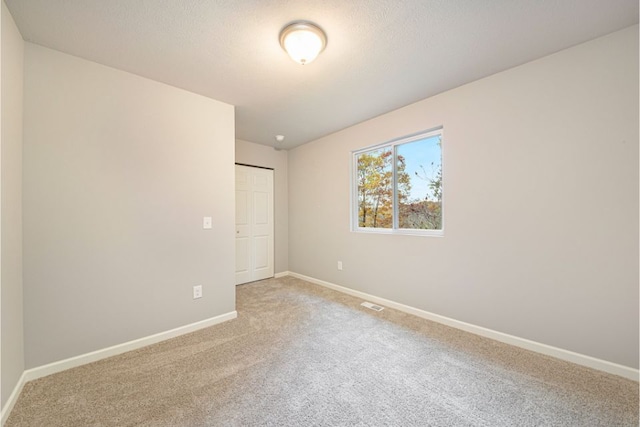 unfurnished bedroom with carpet and a closet