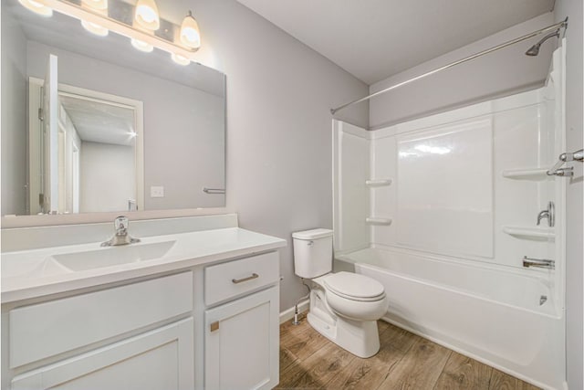 full bathroom featuring vanity, shower / bath combination, hardwood / wood-style flooring, and toilet