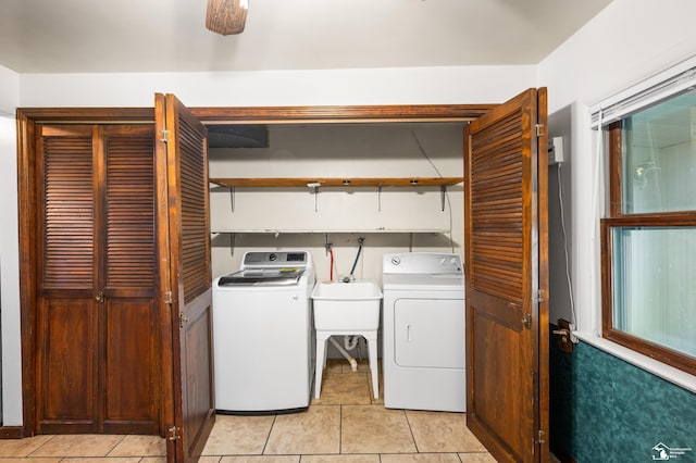 clothes washing area featuring separate washer and dryer and light tile patterned flooring