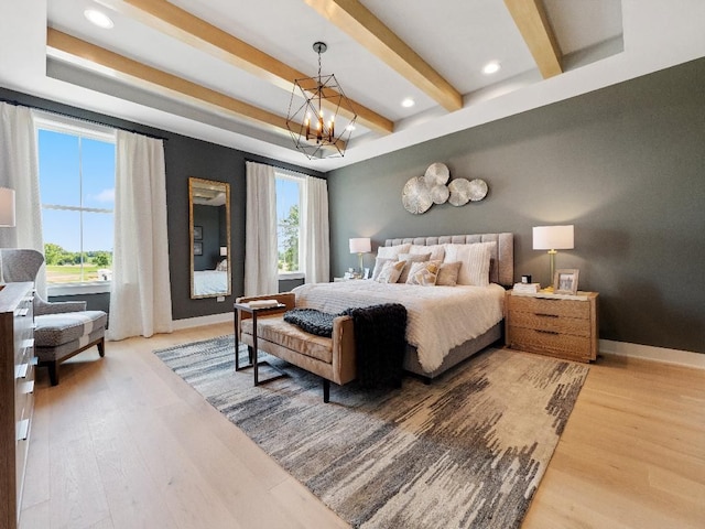 bedroom featuring beamed ceiling, light wood-type flooring, and a chandelier