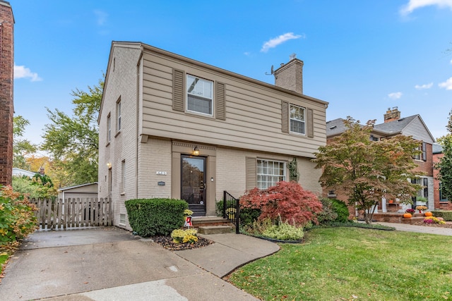 view of property featuring a front lawn