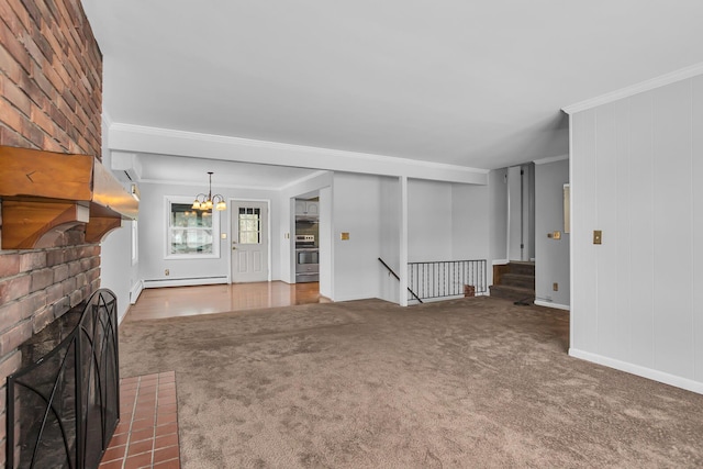 unfurnished living room with carpet flooring, a baseboard radiator, a notable chandelier, a fireplace, and ornamental molding