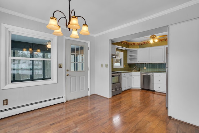 kitchen with white cabinetry, hanging light fixtures, stainless steel appliances, a baseboard radiator, and hardwood / wood-style flooring