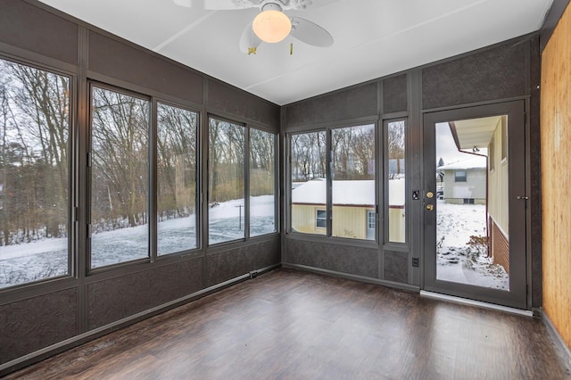 unfurnished sunroom featuring ceiling fan and a healthy amount of sunlight