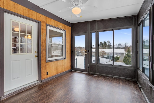 unfurnished sunroom with ceiling fan