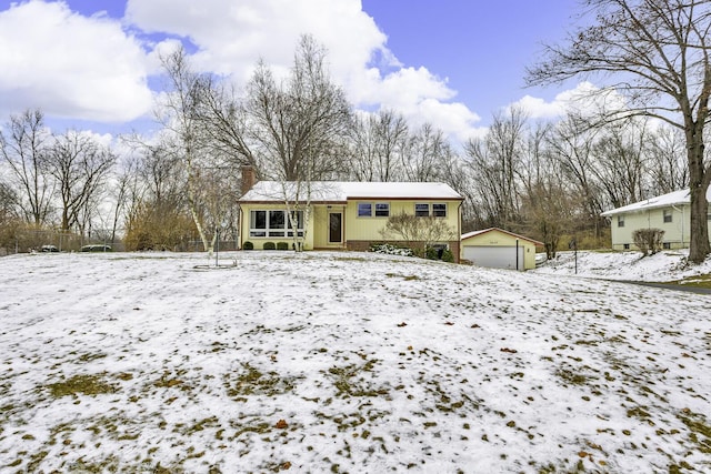 view of front of house with a garage and an outdoor structure