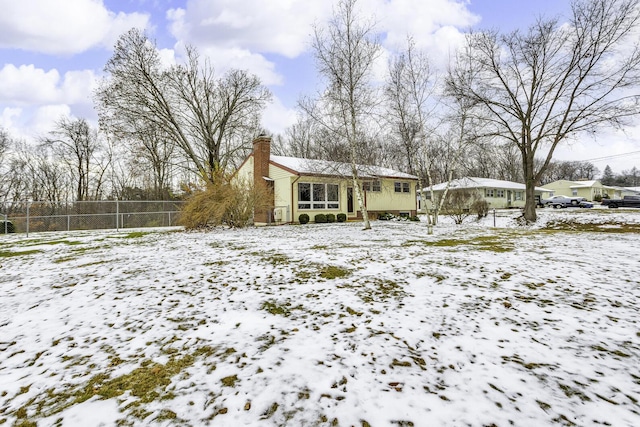 view of snow covered rear of property