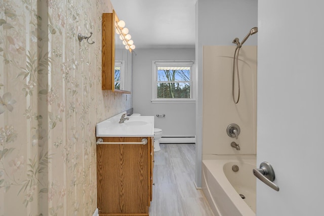 bathroom with washtub / shower combination, hardwood / wood-style floors, vanity, and a baseboard radiator