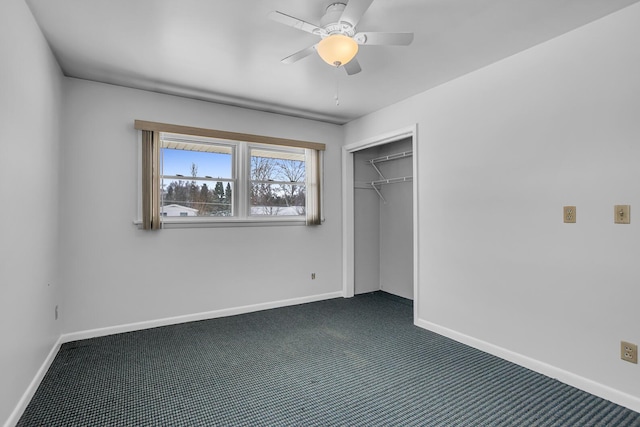 unfurnished bedroom featuring dark colored carpet, a closet, and ceiling fan