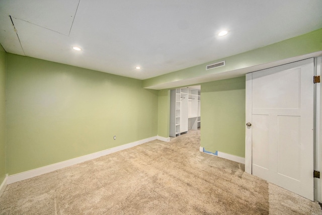 basement featuring light colored carpet