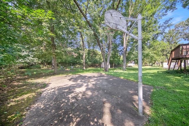 view of patio with a wooden deck and basketball hoop