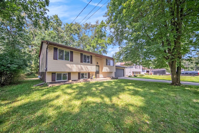 split foyer home with a front yard and a garage