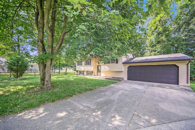 view of front of home with a front yard and a garage