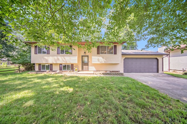 bi-level home with a front yard and a garage