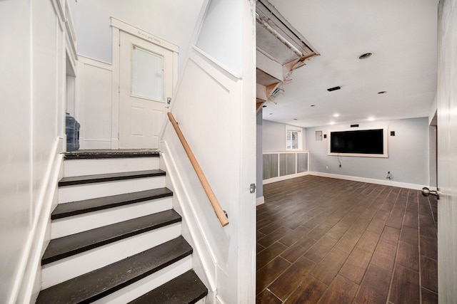 staircase with wood-type flooring