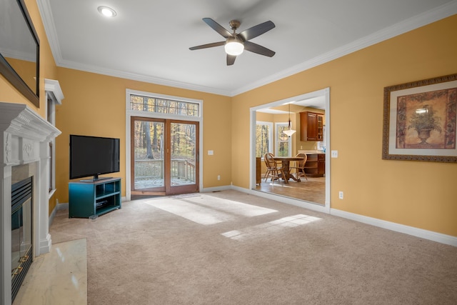 unfurnished living room with light carpet, a fireplace, ceiling fan, and ornamental molding